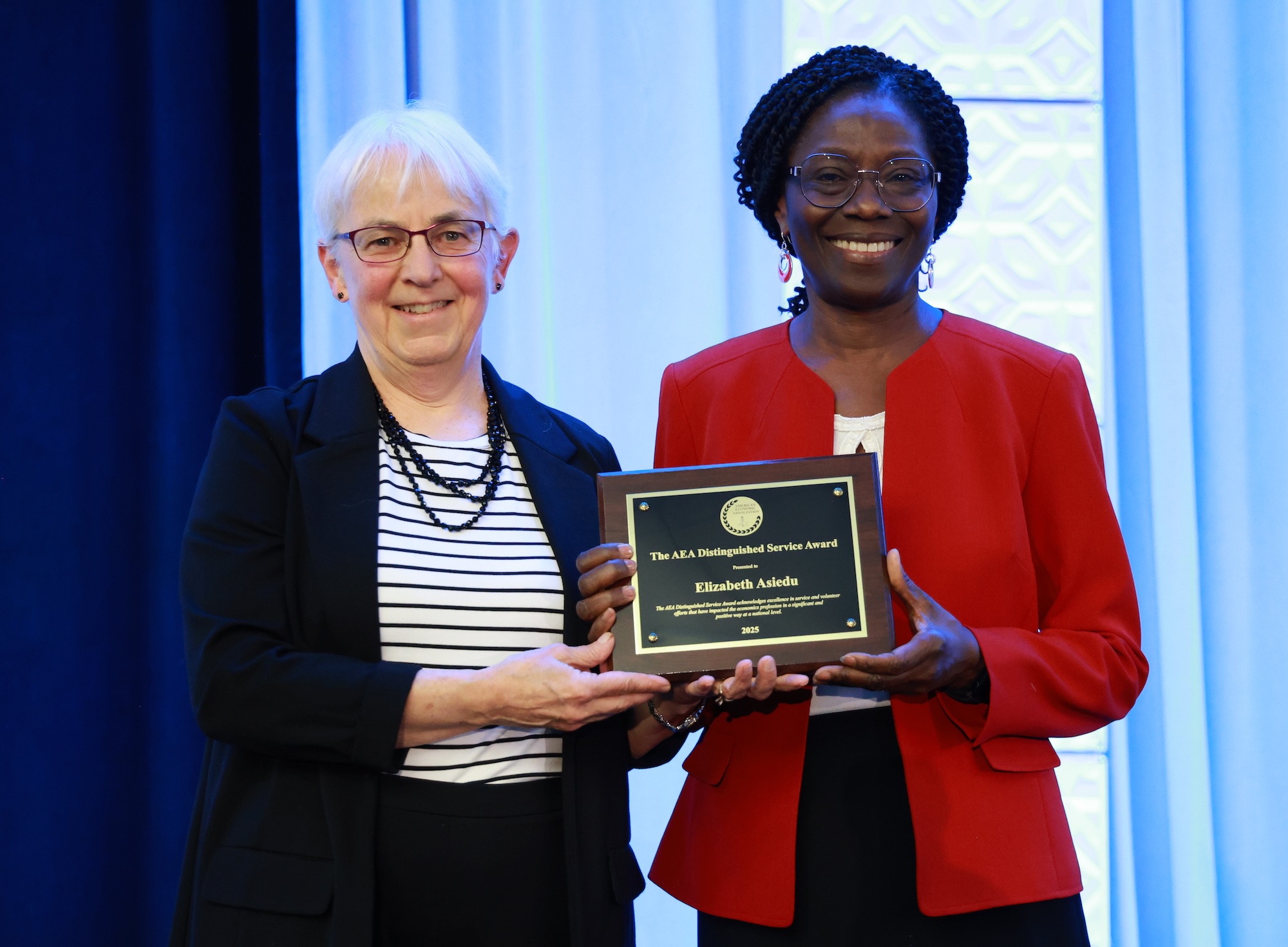 Elizabeth Asiedu receiving Distinguished Service Award